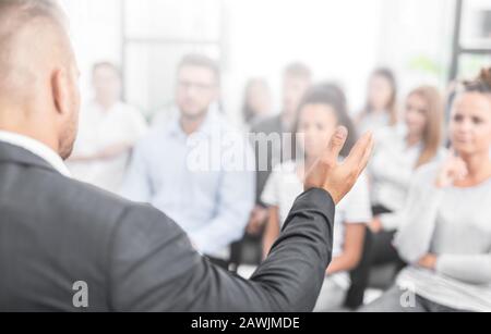 Business coach. Team leader teaches employees at a business meeting in a conference room. Stock Photo