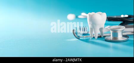 White healthy tooth, different tools for dental care. Dental background. Stock Photo