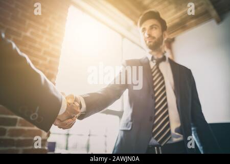 Business people shaking hands, finishing up meeting. Successful businessmen handshaking after good deal. Stock Photo