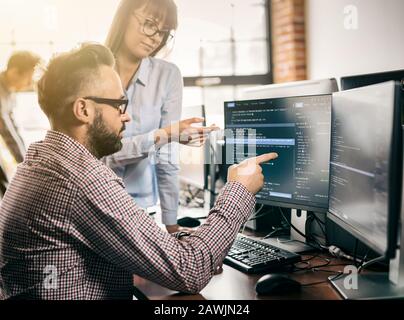 Developing programming and coding technologies. Website design. Programmer working in a software develop company office. Stock Photo
