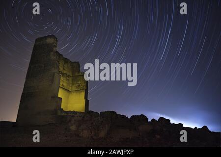 Starry sky achieved by a long exhibition and an old building in ruins Stock Photo