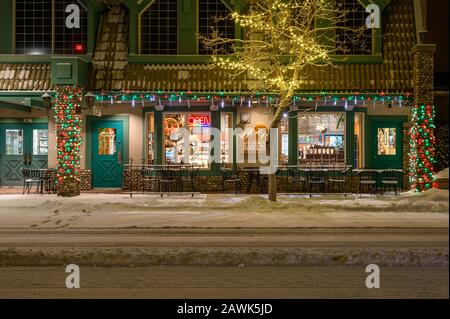 Canmore, Alberta, Canada – February 08, 2020:  Rocky Mountain Bagel Company storefront in downtown as seen at night Stock Photo