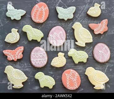 Easter gingerbread cookies decorated with various ornaments on a gray background. Stock Photo