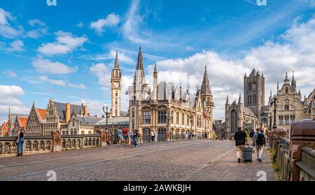 Ghent, Belgium,circa August 2019. People in the Graslei, quay in the promenade next to river Lys in Ghent, Belgium and St Michael's Bridge on a sunny Stock Photo