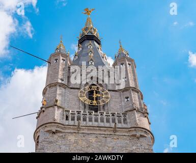 Detail of the top of the Belfry of Ghent on a sunny day. Beautiful architecture and landmark of the medieval city of Gent in Belgium on summer. Stock Photo
