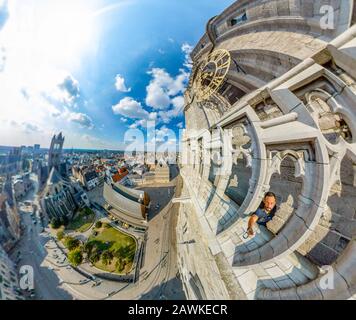 Aerial distorted panorama of The Saint Nicholas Church and Gent cityscape from the Belfry of Ghent on a sunny day. Funny fisheye point of view. Stock Photo