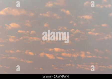 Cumulus sunset clouds with sun setting down. Stock Photo