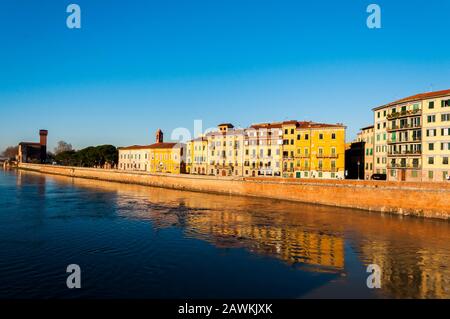 Perfect sunny morning in Pisa on the river, surrounded by old houses Stock Photo