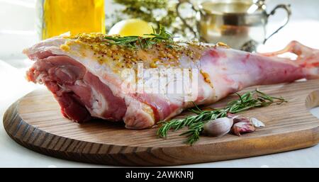 lamb leg raw with olive oil and mustard seeds marinade Stock Photo