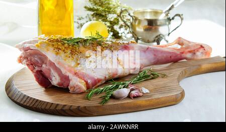 lamb leg raw with olive oil and mustard seeds marinade Stock Photo