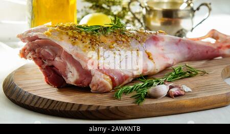 lamb leg raw with olive oil and mustard seeds marinade Stock Photo