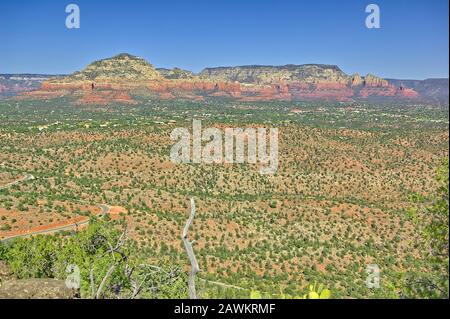 View of central Sedona from the summit of Scheurman Mountain. In the background you can see Capitol Butte, Coffee Pot Rock, and Wilson Mountain. Stock Photo