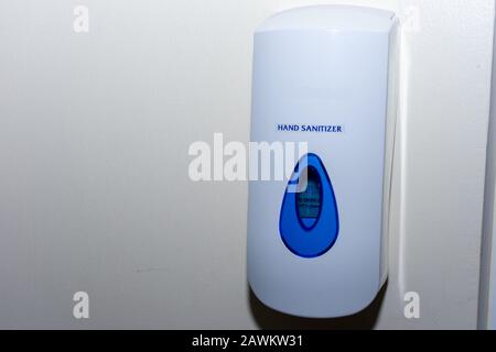 Hand sanitizer dispenser on a wall to protect against illness, bacteria and sickness. Cleanliness and flu concepts. Stock Photo