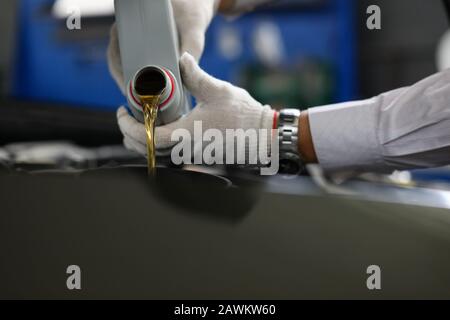 Timely replacement oil in car with new one oil. Stock Photo