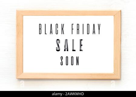 Black Friday sale poster in wooden frame hanging on the wall. Vector illustration Stock Vector