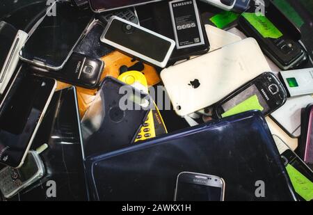 Mosta / Malta - May 11, 2019: Broken mobile digital devices in a bin to be recycled Stock Photo