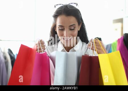 Girl takes pleasure from shopping at boutique. Stock Photo