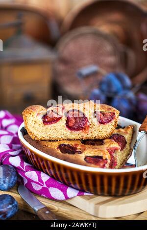 Fresh homemade dimply plum cake on rustic background Stock Photo