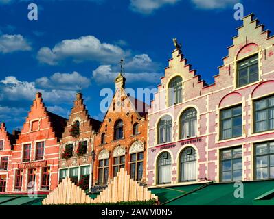 Perspective view traditional colorful Belgian facades of houses at Market square in city of Bruges Belgium Stock Photo