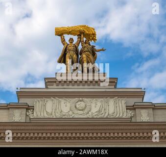 Moscow, Russia - Apr 30. 2018. Sculpture of tractor driver and collective farmer on arch of main entrance to VDNH Stock Photo