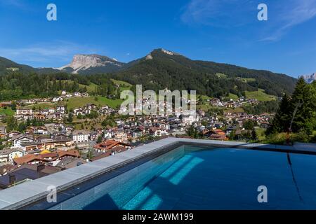 Swimming pool in the Dolomites with a view of Ortisei, Italy Stock Photo