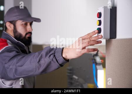 Worker operating a machine in a factory Stock Photo