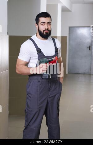 smiling worker with red drill Stock Photo