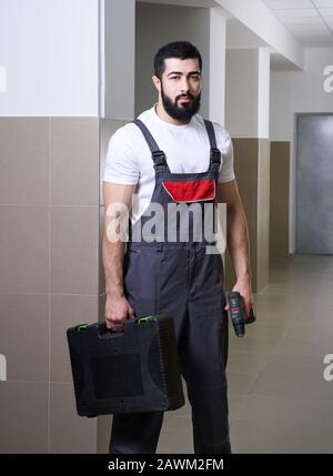 smiling worker with red drill Stock Photo