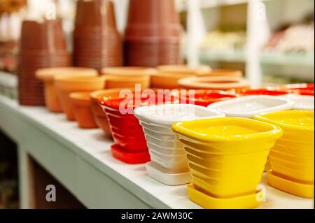 Assortment of empty ceramic flower pots on the shop window. Close-up, selective focus. Stock Photo