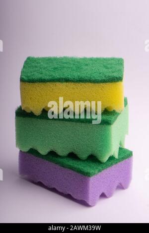 Three multi-colored foam sponges for washing dishes on a white background Stock Photo
