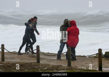 Portland Bill, Dorset, UK.  9th February 2020. UK Weather.  Visitors to Portland Bill in Dorset struggle to stand in the Gale force winds from Storm Ciara.  Picture Credit: Graham Hunt/Alamy Live News