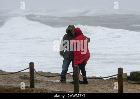 Portland Bill, Dorset, UK.  9th February 2020. UK Weather.  Visitors to Portland Bill in Dorset struggle to stand in the Gale force winds from Storm Ciara.  Picture Credit: Graham Hunt/Alamy Live News