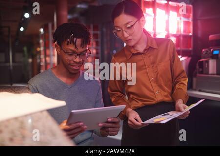 Portrait of contemporary business team working on creative project in futuristic office interior, copy space Stock Photo