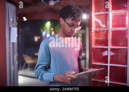 Waist up portrait of contemporary African-American man using digital tablet while working in futuristic office interior, copy space Stock Photo
