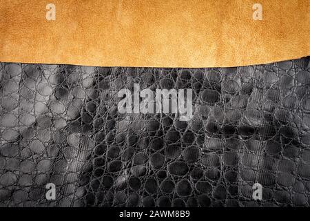 Brown leather and black artificial alligator skin textures background. Stock Photo