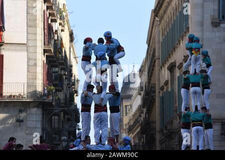 Castellers form castels, human towers, seen during the Santa Elulalia festival in Barcelona.These human towers are built traditionally during the festivals within Catalonia, several teams gather with an attempt to build and dismantle a human tower structure. Stock Photo