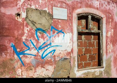 Graffiti on boarded up house, Silves, Algarce, Portugal Stock Photo
