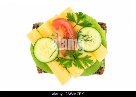 Top view of a healthy sandwich with dark full grain rye bread, vegetables and cheese isolated on a white background without shadows Stock Photo