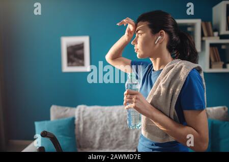 Cute Athletic Young Woman Wiping Her Sweaty Forehead Stock Photo