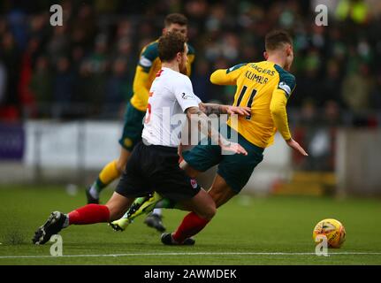 9th February 2020; Broadwood Stadium, Cumbernauld, North Lanarkshire, Scotland; Scottish Cup Football, Clyde versus Celtic; Scott Rumsby of Clyde tackles Patryk Klimala of Celtic Stock Photo