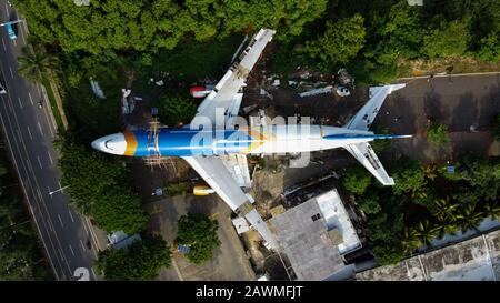 Bekasi, West Java, Indonesia - February 10 2020: SKYLINE AERIAL SHOT. an old airplane on the side of the highway around Bekasi summarecon. repaired wi Stock Photo