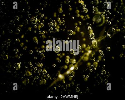 Water bubbles frozen in ice. White bubbles frozen in black ice. Hundreds of air bubbles are locked in the frozen water with no backlight Stock Photo