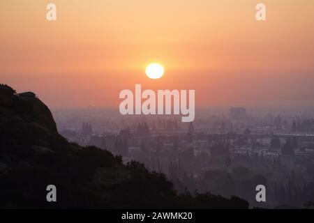 Hazy Los Angeles sunrise hilltop view from Santa Susana Pass State Historic Park near Chatsworth. Stock Photo
