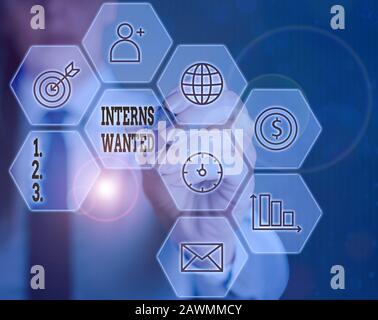 Writing note showing Interns Wanted. Business concept for temporary position with an emphasis on the job training Stock Photo