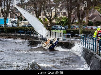 Yacht washed ashore and grounded during Storm Ciara at Cardwell Bay, Gourock, UK with  H M Coastguard in attendance Stock Photo