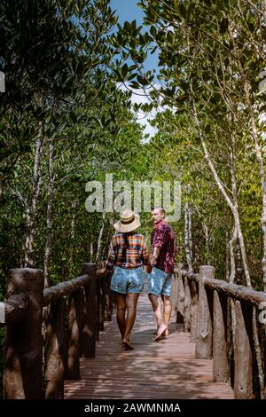 MuKo Chumphon National park,Thailand , couple walking on wooden deck in the park with trees and mangrove in Chumphon Thailand Stock Photo