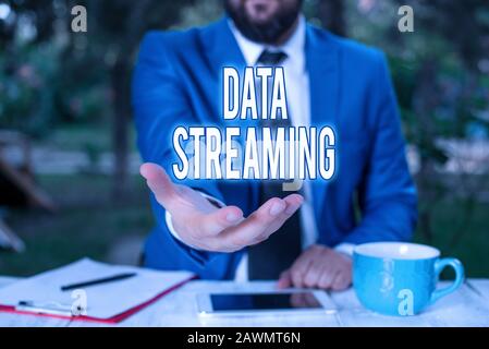 Word writing text Data Streaming. Business photo showcasing data that is continuously generated by different sources Man with opened hands in fron of Stock Photo