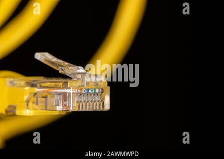 Yellow data cable connector on black background Stock Photo