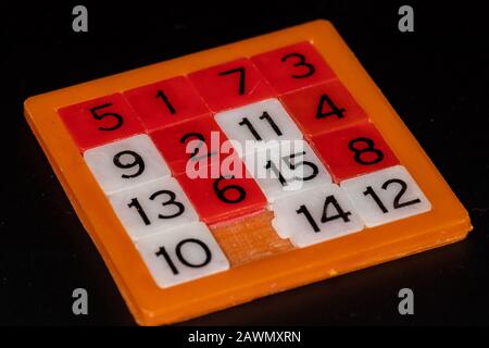 White and red numbers game puzzle on black background Stock Photo