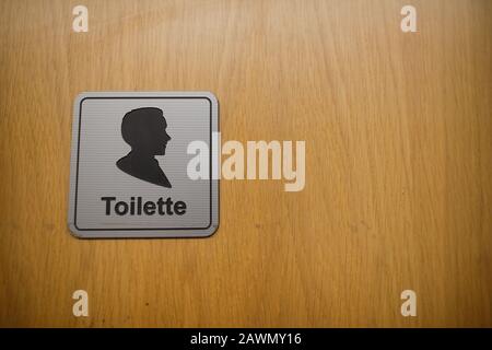 Shallow depth of field (selective focus) image with men toilet sign on a wooden door Stock Photo